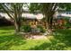 Backyard features a charming garden bench nestled between two mature trees at 1166 Julian Clark Rd, Charleston, SC 29412