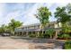 Charming townhome complex featuring brick accents, a covered porch, and ample parking space at 1166 Julian Clark Rd, Charleston, SC 29412