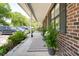 Relaxing front porch with a bench, lush greenery, and view of the parking area at 1166 Julian Clark Rd, Charleston, SC 29412