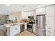 Modern kitchen with white cabinets, stainless steel appliances, and an open layout for entertaining at 1166 Julian Clark Rd, Charleston, SC 29412