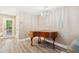 Charming living room featuring a grand piano, chandelier, and hardwood floors at 1166 Julian Clark Rd, Charleston, SC 29412