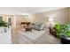 Bright living room featuring a comfortable sofa, piano, chandelier, and hardwood floors at 1166 Julian Clark Rd, Charleston, SC 29412