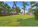 A spacious backyard bordered by mature trees offers privacy and room for outdoor activities at 127 Cornell Dr, Ladson, SC 29456