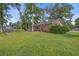 A backyard with well-maintained lawn space features a brick home with a view of the surrounding area at 127 Cornell Dr, Ladson, SC 29456