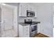 Clean kitchen with stainless steel oven and microwave, granite counters, and white cabinets at 127 Cornell Dr, Ladson, SC 29456