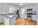 Bright kitchen featuring white cabinets, stainless steel appliances, and subway tile backsplash at 127 Cornell Dr, Ladson, SC 29456