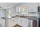 Bright kitchen with granite countertops, stainless steel dishwasher, and white cabinetry at 127 Cornell Dr, Ladson, SC 29456
