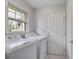 Well-lit laundry room features washer, dryer, and a view to the outside at 127 Cornell Dr, Ladson, SC 29456