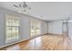 Bright living room featuring beautiful hardwood floors, large windows, and neutral wall color at 127 Cornell Dr, Ladson, SC 29456