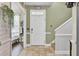 Welcoming foyer with neutral tile flooring, staircase, and a view into the adjacent living area at 172 Cotillion Cresent Cres, Summerville, SC 29483