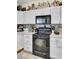Functional kitchen featuring white cabinets, black appliances, and light countertops at 172 Cotillion Cresent Cres, Summerville, SC 29483