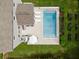 An aerial view of the home, highlighting a pristine pool, manicured lawn, and cozy outdoor seating area at 1825 Crossbill Trl, Hanahan, SC 29410