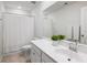 Well-lit bathroom featuring a large mirror, white cabinets, a toilet, and a shower behind a white shower curtain at 1825 Crossbill Trl, Hanahan, SC 29410