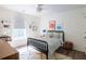 Bright bedroom featuring a black spindle bed frame, playful art, and a cozy patterned rug on wood floors at 1825 Crossbill Trl, Hanahan, SC 29410