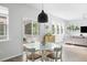 Bright and airy dining area next to the screened porch and living area at 1825 Crossbill Trl, Hanahan, SC 29410