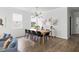 Dining area with a modern light fixture, clean lines, and bright natural light illuminating the space at 1825 Crossbill Trl, Hanahan, SC 29410