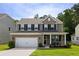 Charming two-story home with a combination brick and vinyl exterior and a well-manicured front lawn at 1825 Crossbill Trl, Hanahan, SC 29410