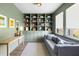 Cozy living room with custom built-in shelving, soft gray sofa, and large windows offering natural light at 1825 Crossbill Trl, Hanahan, SC 29410