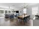 Open-concept living and dining area with modern lighting, sleek wood floors, and bright, airy atmosphere at 1825 Crossbill Trl, Hanahan, SC 29410