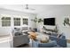 Living room with a spacious seating area, modern decor, and plenty of natural light from large windows at 1825 Crossbill Trl, Hanahan, SC 29410