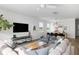 Comfortable living room featuring a large flat-screen TV, stylish decor, and an open layout to the dining area at 1825 Crossbill Trl, Hanahan, SC 29410