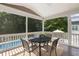 Covered patio featuring an outdoor dining set with a pool view, perfect for entertaining and relaxation at 1825 Crossbill Trl, Hanahan, SC 29410
