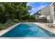 Refreshing pool with ample seating and lush landscaping, perfect for outdoor relaxation and entertaining at 1825 Crossbill Trl, Hanahan, SC 29410