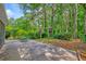 A spacious patio with mature trees perfect for entertaining or relaxing outdoors at 202 Hunt Club Dr, Summerville, SC 29485
