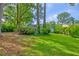 Spacious backyard surrounded by mature trees, providing shade and privacy at 202 Hunt Club Dr, Summerville, SC 29485