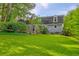 Secluded backyard with lush green lawn and a screened porch for outdoor enjoyment at 202 Hunt Club Dr, Summerville, SC 29485