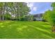 Expansive backyard with lush green lawn and mature trees offering privacy and space for outdoor activities at 202 Hunt Club Dr, Summerville, SC 29485