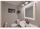 A compact bathroom features a modern sink, toilet, and decorative wall art for a functional space at 202 Hunt Club Dr, Summerville, SC 29485