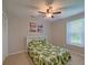 Serene bedroom with natural light, showcasing a charming bed with a patterned comforter at 202 Hunt Club Dr, Summerville, SC 29485