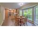 Bright dining area featuring a large bay window and wood flooring, flowing into the kitchen at 202 Hunt Club Dr, Summerville, SC 29485