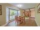 Cozy dining area with a round table, bay window, and wood-look flooring at 202 Hunt Club Dr, Summerville, SC 29485