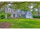 Charming home with dormer windows, attached garage, lush landscaping, and a bench in front at 202 Hunt Club Dr, Summerville, SC 29485