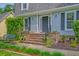 Close up of a brick porch featuring black railings and beautiful landscaping at 202 Hunt Club Dr, Summerville, SC 29485