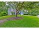 Charming home with a well-manicured lawn and mature trees at 202 Hunt Club Dr, Summerville, SC 29485