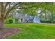 Beautiful home with lush green lawn, mature trees, and a long driveway leading to a garage at 202 Hunt Club Dr, Summerville, SC 29485