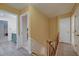 Hallway with wood floors that shows entry into a bathroom with green vanity and marble countertop at 202 Hunt Club Dr, Summerville, SC 29485