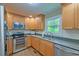 Bright kitchen featuring stainless steel appliances, granite countertops, and tile backsplash at 202 Hunt Club Dr, Summerville, SC 29485