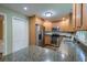 Well-equipped kitchen features granite countertops, stainless steel appliances, and wooden cabinetry at 202 Hunt Club Dr, Summerville, SC 29485