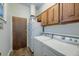 Functional laundry room with washer, dryer, cabinets, and efficient storage solutions at 202 Hunt Club Dr, Summerville, SC 29485