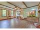 Open living room with unique ceiling beams, tiled floors, and a view into the kitchen at 202 Hunt Club Dr, Summerville, SC 29485