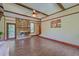 Living room featuring brick fireplace, hardwood floors, with a door leading to the screened porch at 202 Hunt Club Dr, Summerville, SC 29485