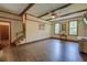 Spacious living room with hardwood floors and stairs, showcasing natural light and cozy ambiance at 202 Hunt Club Dr, Summerville, SC 29485