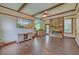 Inviting living room showcasing a brick fireplace, wood-beamed ceiling, and wood-style flooring at 202 Hunt Club Dr, Summerville, SC 29485
