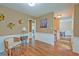 Spacious living room with wood floors, wainscoting, and neutral paint at 202 Hunt Club Dr, Summerville, SC 29485
