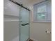 A well-lit shower features a sliding glass door and white tiled walls, offering a clean and modern look at 202 Hunt Club Dr, Summerville, SC 29485