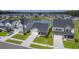 Aerial view of homes in a community with a pond, showcasing neighborhood layout and green spaces at 206 Camellia Bloom Dr, Moncks Corner, SC 29461